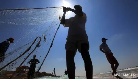 Palestinian fishermen prepare their trawl for fishing at the sea front in Deir al-Balah Palestinian refugee camp, central of Gaza Strip, on September 19, 2012. Photo by Majdi Fathi