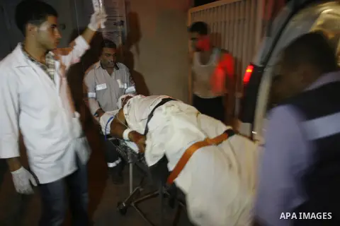 Palestinian medics wheel a wounded person to an ambulance At Al Najar hospital following an Israeli air strike in Rafah southern Gaza Strip, Wednesday, Sept. 19, 2012. A Palestinian health official says an Israeli airstr...