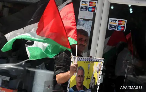 Palestinians hold portraits of relatives held in Israeli jails during a protest to calling for their liberty, in Gaza city on September 20, 2012. Photo by Majdi Fathi