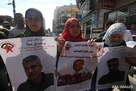 Palestinians hold portraits of relatives held in Israeli jails during a protest to calling for their liberty, in Gaza city on September 20, 2012. Photo by Majdi Fathi
