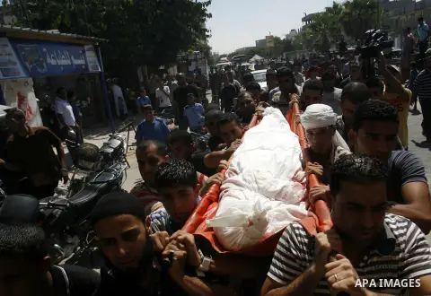 Palestinian Mourners carry the body of a Palestinian militant Ibrahim Abu Enein during his funeral in Rafah, southern Gaza Strip, on September 20, 2012. An Israeli air strike on the Gaza Strip killed two Palestinians and...
