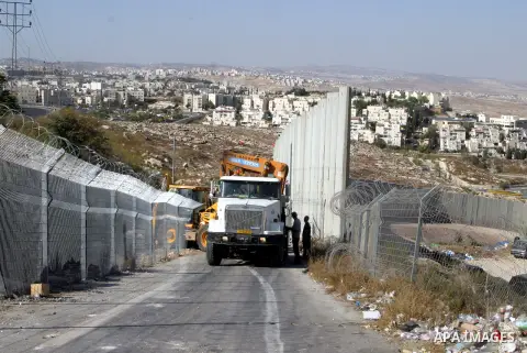 An Israeli bulldozer works to sealing off the Ras Khamis Checkpoint northen jerusalem on Sept. 20, 2012. The Israeli Ministry of Defence has announced its plans to seal off one of two checkpoints through which the 65,000...