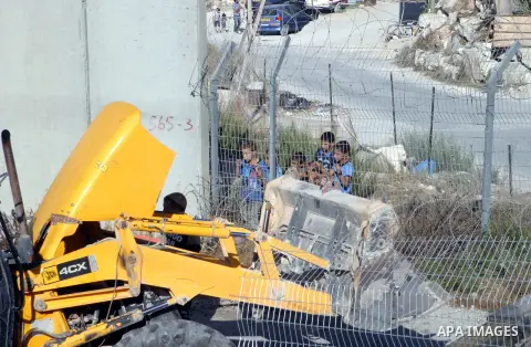 An Israeli bulldozer works to sealing off the Ras Khamis Checkpoint northen jerusalem on Sept. 20, 2012. The Israeli Ministry of Defence has announced its plans to seal off one of two checkpoints through which the 65,000...