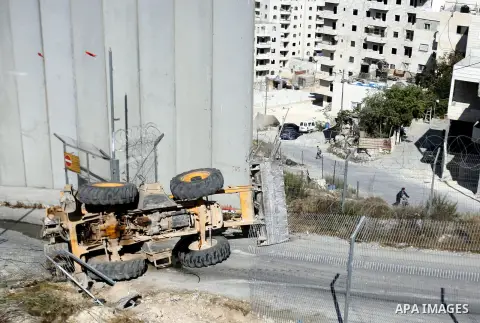 An Israeli bulldozer inverses during sealing off the Ras Khamis Checkpoint northen jerusalem on Sept. 20, 2012. The Israeli Ministry of Defence has announced its plans to seal off one of two checkpoints through which the...