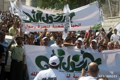 Palestinian protesters shout slogans and wave flags during a protest in the West Bank town of Ramallah against an anti-Islam movie made in the U.S. and French cartoons said to insult the Prophet Muhammad, 21 September 20...