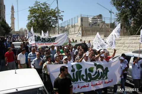 Palestinian protesters shout slogans and wave flags during a protest in the West Bank town of Ramallah against an anti-Islam movie made in the U.S. and French cartoons said to insult the Prophet Muhammad, 21 September 20...