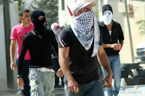 Palestinian protesters throw stones at Israeli soldiers during a demonstration against the expropriation of Palestinian land by Israel in the village of Kfar Qaddum, near the West Bank city of Nablus, on september 21, 20...