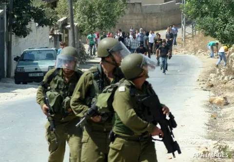 Israeli soldiers fire tear gas toward Palestinian protesters during a demonstration against the expropriation of Palestinian land by Israel in the village of Kfar Qaddum, near the West Bank city of Nablus, on september 2...