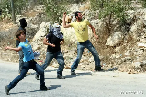 Palestinian protesters throw stones at Israeli soldiers during a demonstration against the expropriation of Palestinian land by Israel in the village of Kfar Qaddum, near the West Bank city of Nablus, on september 21, 20...