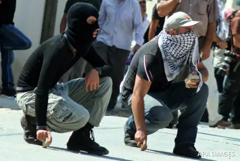 Palestinian protesters throw stones at Israeli soldiers during a demonstration against the expropriation of Palestinian land by Israel in the village of Kfar Qaddum, near the West Bank city of Nablus, on september 21, 20...