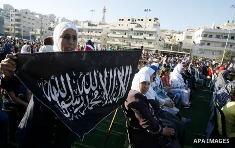 Palestinians chant slogans during a gathering denouncing an US-produced amateur film mocking Islam's Prophet Mohammed and cartoons published in a French satirical magazine Charlie Hebdo, in the Issawiya district of Arab...