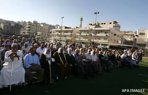 Palestinians chant slogans during a gathering denouncing an US-produced amateur film mocking Islam's Prophet Mohammed and cartoons published in a French satirical magazine Charlie Hebdo, in the Issawiya district of Arab...