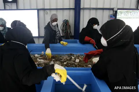 Palestinian women sort solid waste for production compost in station in Rafah in the southern Gaza Strip, on Sep. 23, 2012 Some Palestinians, driven by poverty exacerbated by the Israeli blockade and lack of employment o...