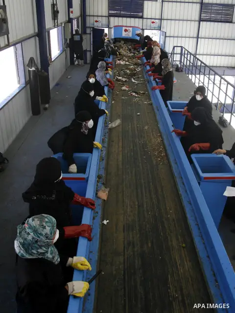 Palestinian women sort solid waste for production compost in station in Rafah in the southern Gaza Strip, on Sep. 23, 2012 Some Palestinians, driven by poverty exacerbated by the Israeli blockade and lack of employment o...