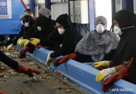 Palestinian women sort solid waste for production compost in station in Rafah in the southern Gaza Strip, on Sep. 23, 2012 Some Palestinians, driven by poverty exacerbated by the Israeli blockade and lack of employment o...