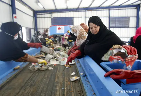 Palestinian women sort solid waste for production compost in station in Rafah in the southern Gaza Strip, on Sep. 23, 2012 Some Palestinians, driven by poverty exacerbated by the Israeli blockade and lack of employment o...