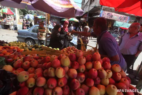 A Palestinian vendor displays fruits at a market in Gaza city, Sept. 23, 2012. The ministry of agriculture in Gaza government decided stop import fruits from Israel except apples and bananas to support the local fruits p...