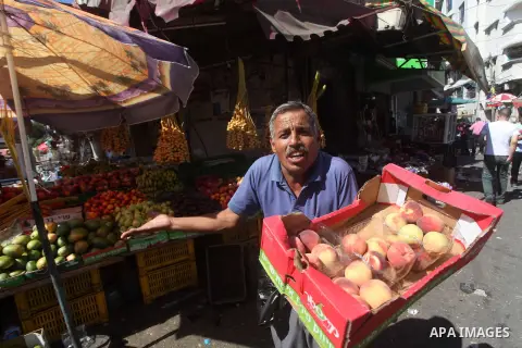 A Palestinian vendor displays fruits at a market in Gaza city, Sept. 23, 2012. The ministry of agriculture in Gaza government decided stop import fruits from Israel except apples and bananas to support the local fruits p...