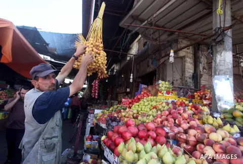 A Palestinian vendor displays fruits at a market in Gaza city, Sept. 23, 2012. The ministry of agriculture in Gaza government decided stop import fruits from Israel except apples and bananas to support the local fruits p...