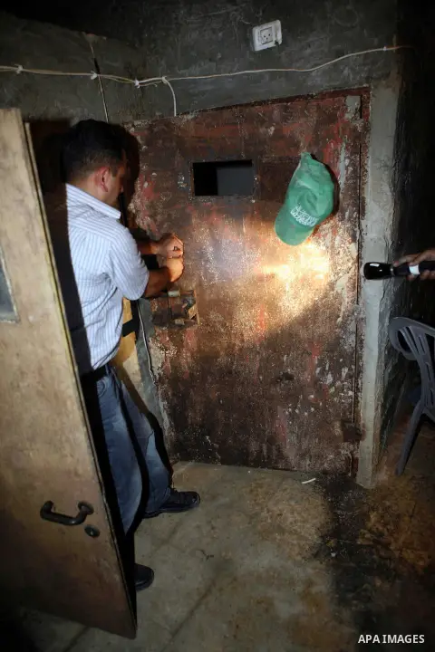 Palestinian plain clothed security inspects a room built under a house in the West Bank village of Urif, south of the northern city of Nablus on September 23, 2012. Palestinian security believe a network of tunnels, room...