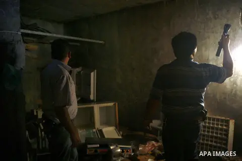 Palestinian plain clothed security inspects a room built under a house in the West Bank village of Urif, south of the northern city of Nablus on September 23, 2012. Palestinian security believe a network of tunnels, room...