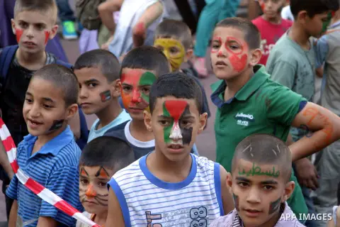 Palestinian children attend the Jerusalemite cakes festival in al-Sheikh Jarrah neighborhood in the east of Jerusalem city, on 23 September 2012. Photo by Mahfouz Abu Turk