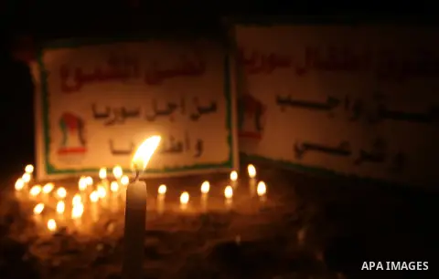 Palestinian children lite candles during a rally to show solidarity with Syrian mothers and children who suffer most in civil war, in Jabalia refugee camp northen Gaza strip, September 24, 2012. The UN Security Council s...