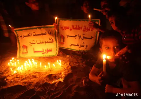 Palestinian children lite candles during a rally to show solidarity with Syrian mothers and children who suffer most in civil war, in Jabalia refugee camp northen Gaza strip, September 24, 2012. The UN Security Council s...