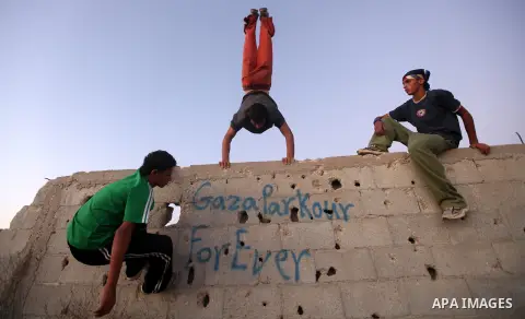 Palestinian youths practice their parkour skills in Khan Younis in southern Gaza Strip on 24 September 2012. Parkour originating in France is the physical practice of traversing elements in both urban and rural settings...