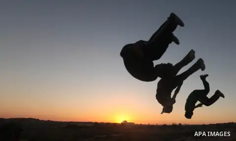 Palestinian youths practice their parkour skills in Khan Younis in southern Gaza Strip on 24 September 2012. Parkour originating in France is the physical practice of traversing elements in both urban and rural settings...