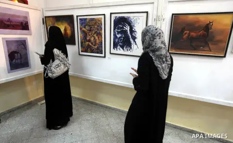 Palestinians look at paintings during an abstract painting show in Gaza city, on 24 September 2012. Photo by Majdi Fathi