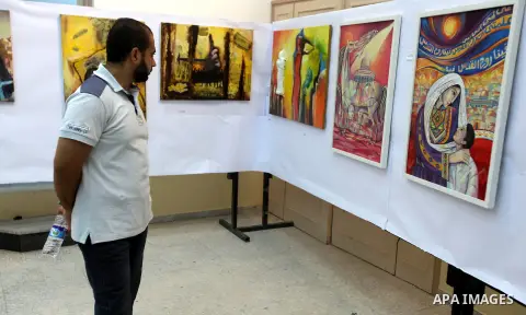 A Palestinian youth looks at paintings during an abstract painting show in Gaza city, on 24 September 2012. Photo by Majdi Fathi