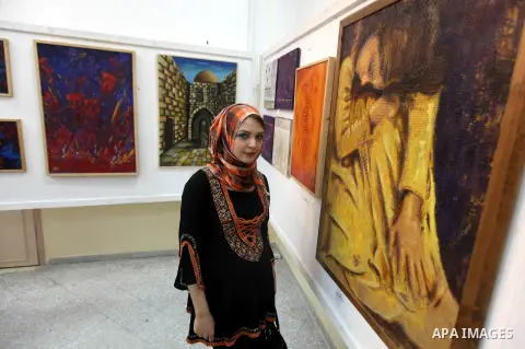 A Palestinian youth looks at paintings during an abstract painting show in Gaza city, on 24 September 2012. Photo by Majdi Fathi