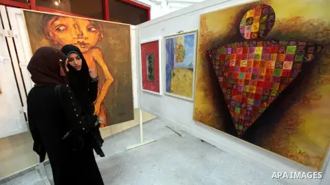 Palestinians look at paintings during an abstract painting show in Gaza city, on 24 September 2012. Photo by Majdi Fathi
