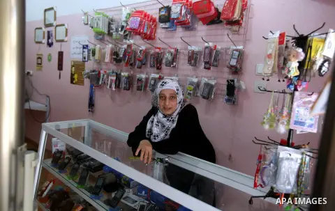 Palestinian Fatma al-Halouli stands at her cell phones shop in Gaza city on 25 September 2012. The International Monetary Fund (IMF) noted that growth has slowed and unemployment risen in both the West Bank and the Gaza...