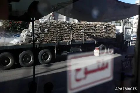 A Palestinian worker stands on a lorry laden with cement comming from the smuggling tunnels in Rafah, in Gaza city, Sept. 25, 2012. The tunnels trade, which analysts estimate is worth half a billion dollars a year, bring...
