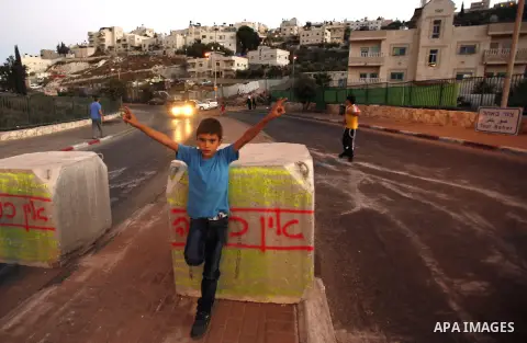 Palestinian children ride their bicycles during closing the roads between the Israeli settlements and the Arab neighborhoods by the Israeli border police in Jerusalem's old city, Sept. 25, 2012. Closes early for Yom Kipp...
