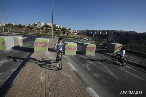 Palestinian children ride their bicycles during closing the roads between the Israeli settlements and the Arab neighborhoods by the Israeli border police in Jerusalem's old city, Sept. 26, 2012. Closes early for Yom Kipp...