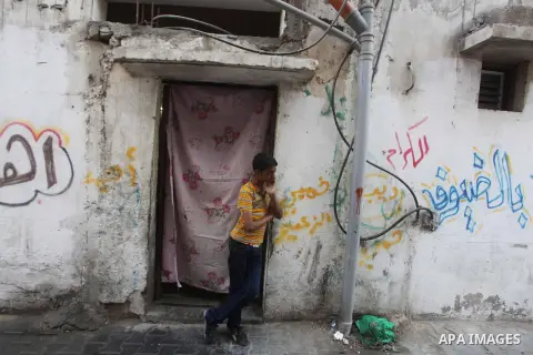 A Palestinian brother of one-year-old Fathi Baghdadi weeps, who died after a fire from a candle that swept through their home in the Bureij refugee camp in the center of the Gaza Strip on September 26, 2012. The Baghdadi...