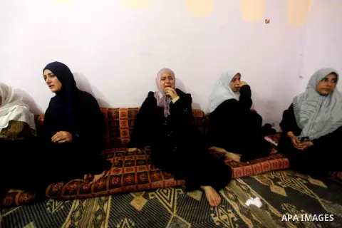 Palestinian relatives of one-year-old Fathi Baghdadi weeps, who died after a fire from a candle that swept through their home in the Bureij refugee camp in the center of the Gaza Strip on September 26, 2012. The Baghdadi...
