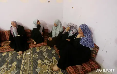 Palestinian relatives of one-year-old Fathi Baghdadi weeps, who died after a fire from a candle that swept through their home in the Bureij refugee camp in the center of the Gaza Strip on September 26, 2012. The Baghdadi...