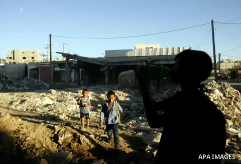 Palestinian children stand near an erupting sewage pipeline, in Rafah refugee camp southern the Gaza strip, Sept 26, 2012. In the aftermath of the Israeli military Operation Cast Lead in 2008/2009, Palestinian refugees i...