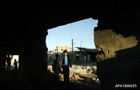 Palestinian students pass through an erupting sewage pipeline, in Rafah refugee camp southern the Gaza strip, Sept 26, 2012. In the aftermath of the Israeli military Operation Cast Lead in 2008/2009, Palestinian refugees...