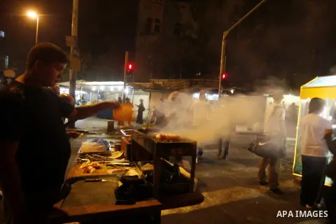 A Palestinian vendor grills meat at the market in Jerusalem's old city on 27 September 2012. Photo by Mahfouz Abu Turk