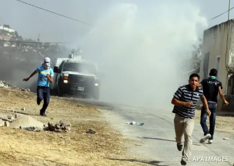 An Israeli truck spray foul smelling water towards Palestinian protesters after a demonstration against the expropriation of Palestinian land by Israel in the village of Kfar Qaddum, near the West Bank city of Nablus, on...