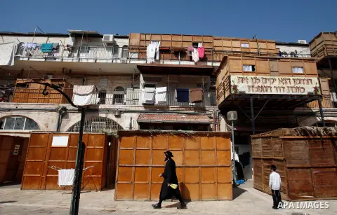 An Ultra-Orthodox Jewish man walks in the ultra-Orthodox neighbourhood of Meah Shearim during the preparation for the celebration of Sukkot, the Feast of the Tabernacles, in Jerusalem on September 28, 2012. The Sukkot fe...