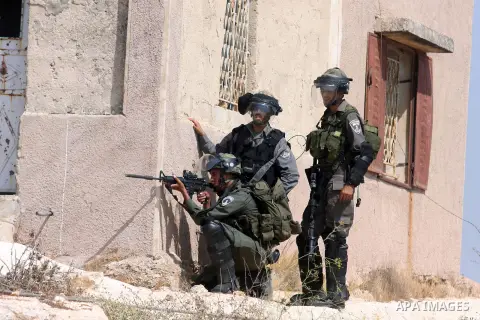 Israeli soldiers fire at Palestinian protesters during a weekly protest against the expansion of the nearby Jewish settlement of Halamish, in the West Bank village of Nabi Saleh near Ramallah, Friday, Sept 28, 2012. Phot...