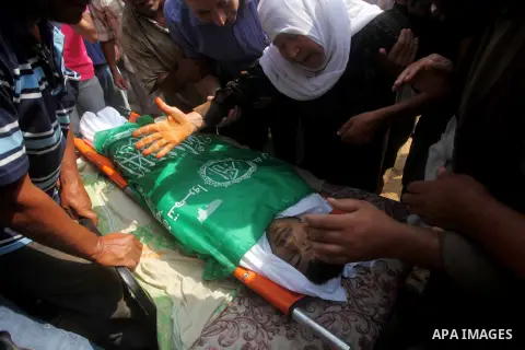Relatives of Palestinian fisherman Fahmi Abu Rayash mourn over his body during his funeral in Beit Lahia in the northern Gaza Strip on September 29, 2012. Abu Rayash died of his wounds after the Israeli navy opened fire...