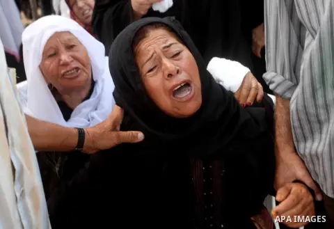 Relatives of Palestinian fisherman Fahmi Abu Rayash mourn over his body during his funeral in Beit Lahia in the northern Gaza Strip on September 29, 2012. Abu Rayash died of his wounds after the Israeli navy opened fire...
