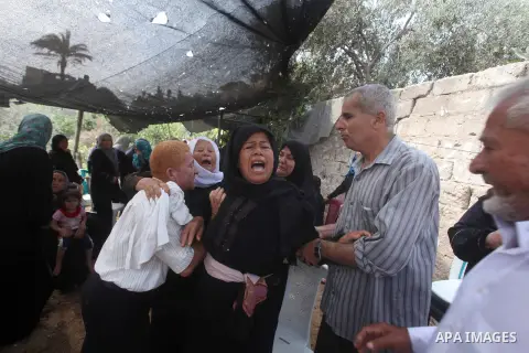 Relatives of Palestinian fisherman Fahmi Abu Rayash mourn over his body during his funeral in Beit Lahia in the northern Gaza Strip on September 29, 2012. Abu Rayash died of his wounds after the Israeli navy opened fire...